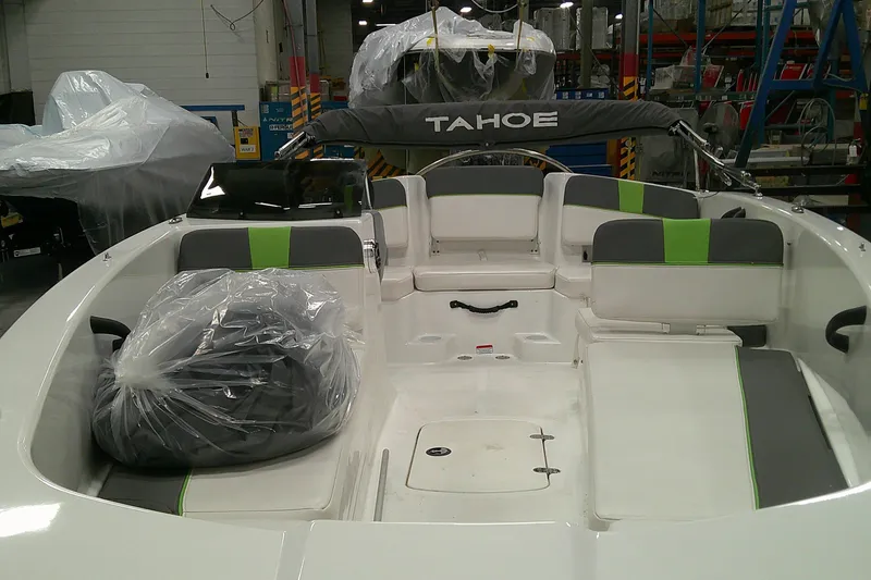 Slide: The Image of 2023 Tahoe T18 boat interior with green accents, in a manufacturing facility. - 3