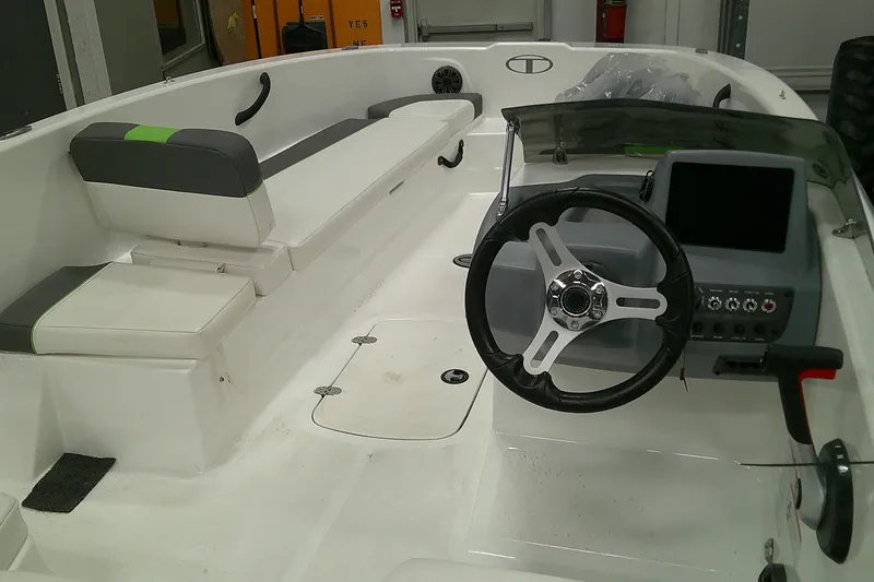 Slide: The Image of 2023 Tahoe T18 boat interior with steering wheel and seating area. - 4