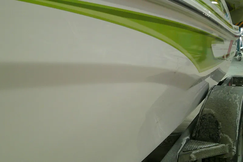 Slide: The Image of 2023 Tahoe T18 boat with green stripe detail on trailer. - 6