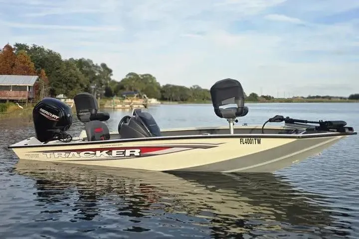 The Image of 2025 Tracker Pro Team 175 Crappie Edition boat on a calm lake. - 1