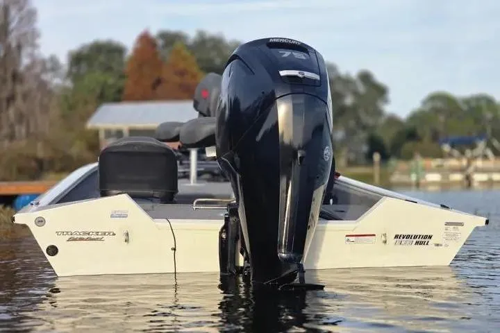 Slide: The Image of 2025 Tracker Pro Team 175 Crappie Edition boat with Mercury engine on a calm lake. - 12