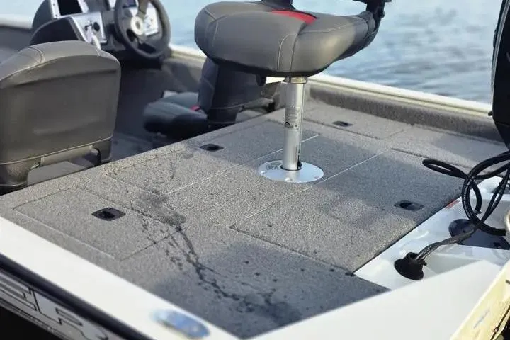 Slide: The Image of 2025 Tracker Pro Team 175 Crappie Edition boat interior with seating and steering wheel. - 13