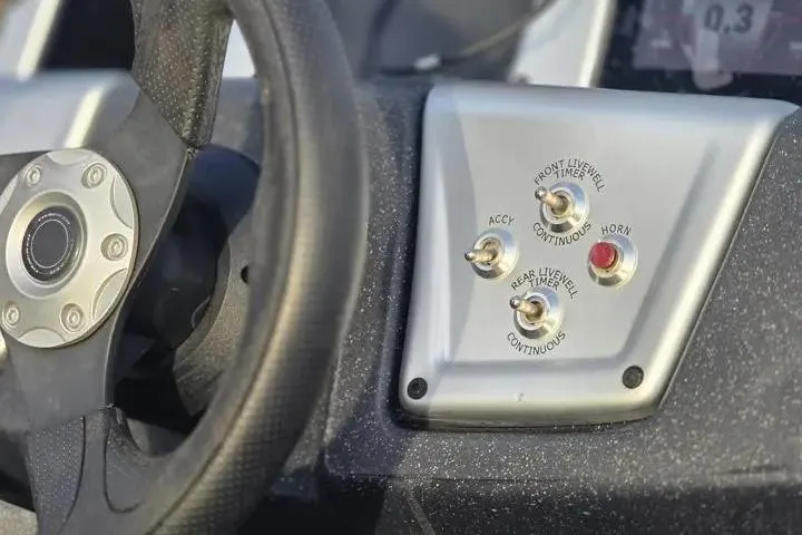Slide: The Image of Steering wheel and control panel of 2025 Tracker Pro Team 175 Crappie Edition boat. - 16