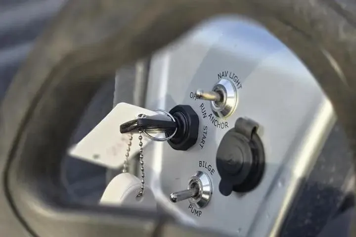 Slide: The Image of Control panel of 2025 Tracker Pro Team 175 Crappie Edition boat with ignition and switches. - 17