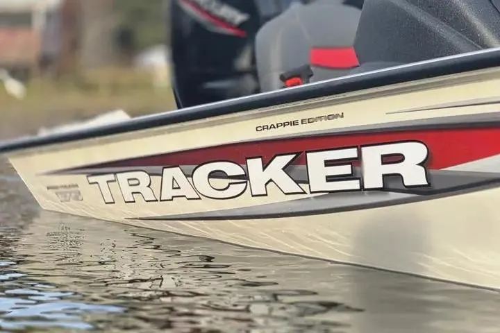 Slide: The Image of 2025 Tracker Pro Team 175 Crappie Edition boat on water, close-up view. - 3