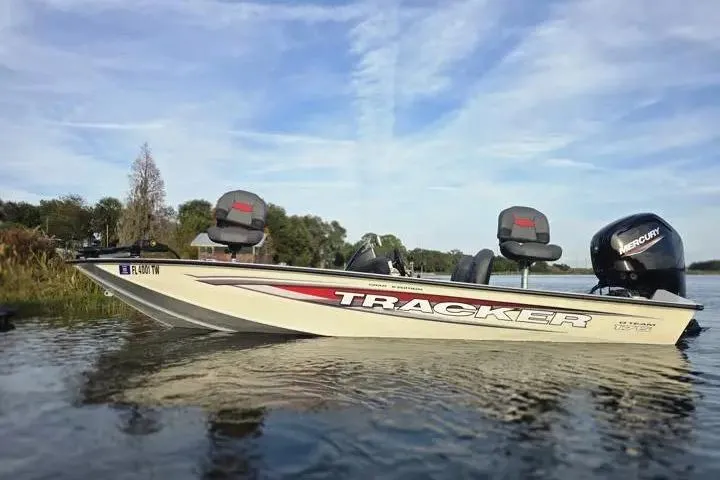 Slide: The Image of 2025 Tracker Pro Team 175 Crappie Edition boat on calm lake water. - 9