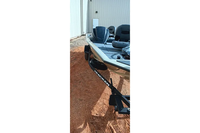 Slide: The Image of 2026 Tracker Pro Team 175 Crappie Edition boat on trailer, parked on dirt. - 11