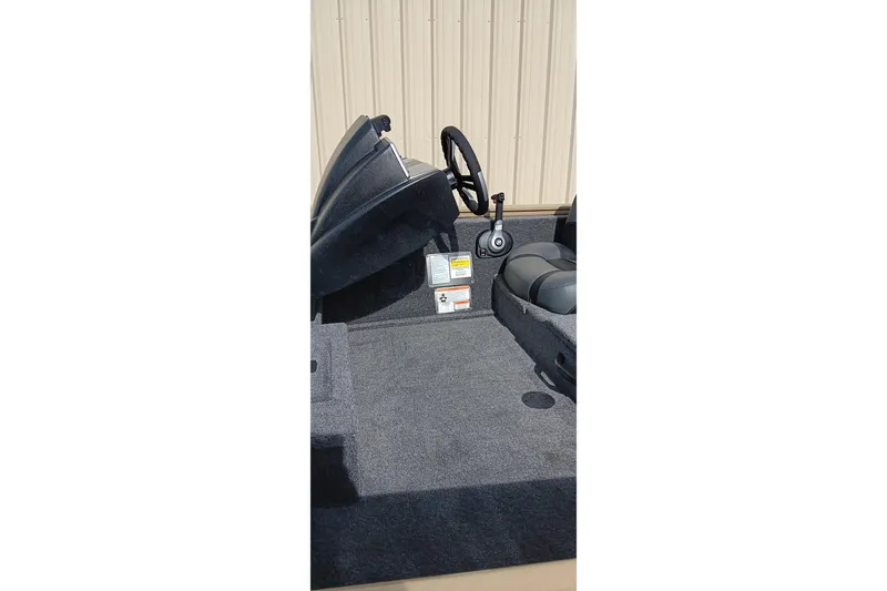 Slide: The Image of 2026 Tracker Pro Team 175 Crappie Edition boat interior with steering wheel and seating. - 13