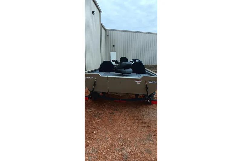 Slide: The Image of 2026 Tracker Pro Team 175 Crappie Edition boat parked outside a building. - 16