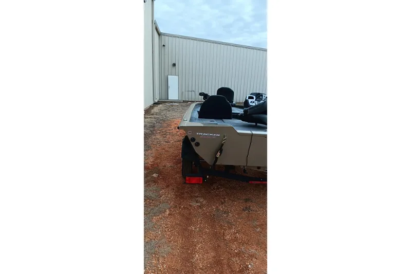 Slide: The Image of 2026 Tracker Pro Team 175 Crappie Edition boat parked outside a building. - 17