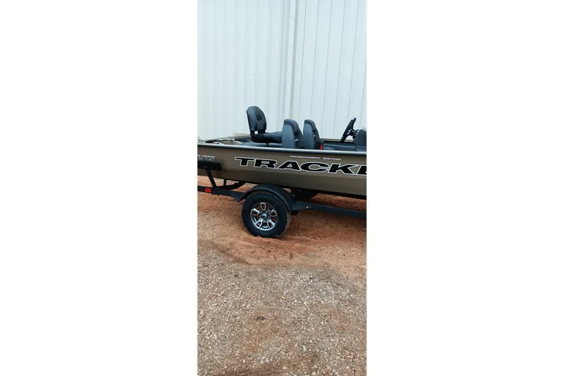 Slide: The Image of 2026 Tracker Pro Team 175 Crappie Edition boat on trailer, parked outdoors. - 2
