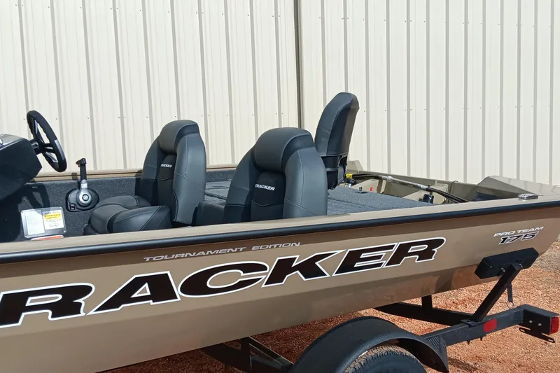 Slide: The Image of 2026 Tracker Pro Team 175 Crappie Edition boat with sleek seating and steering wheel. - 9