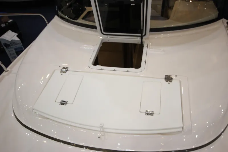 Slide: The Image of 2026 Ranger Tugs R-27 boat deck with open hatch and sleek design. - 28