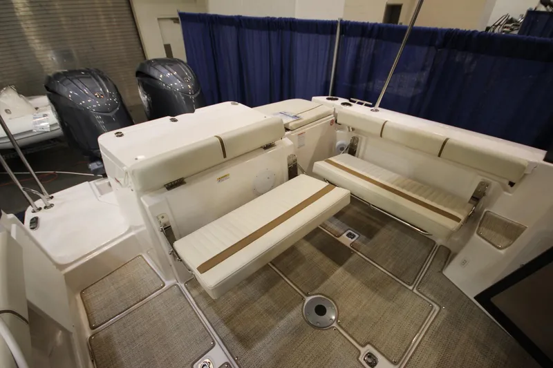 Slide: The Image of 2026 Ranger Tugs R-27 boat interior with foldable seating and dual outboard motors. - 6
