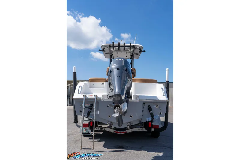 Slide: The Image of 2021 Sea Hunt Ultra 229 boat with outboard motor, viewed from the rear under a clear sky. - 12