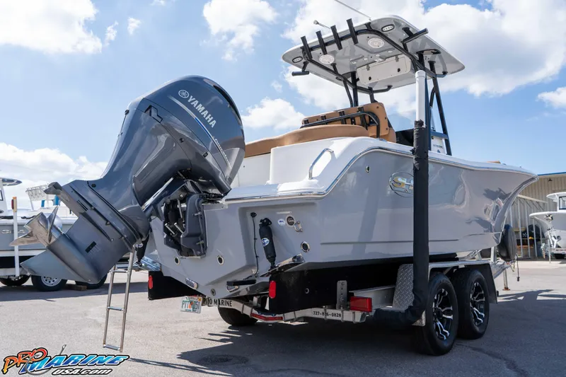 Slide: The Image of 2021 Sea Hunt Ultra 229 boat with Yamaha engine on trailer, parked outdoors. - 14