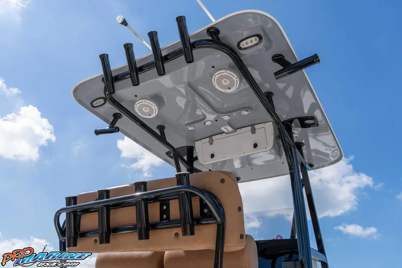 Slide: The Image of 2021 Sea Hunt Ultra 229 boat with T-top and rod holders against blue sky. - 17