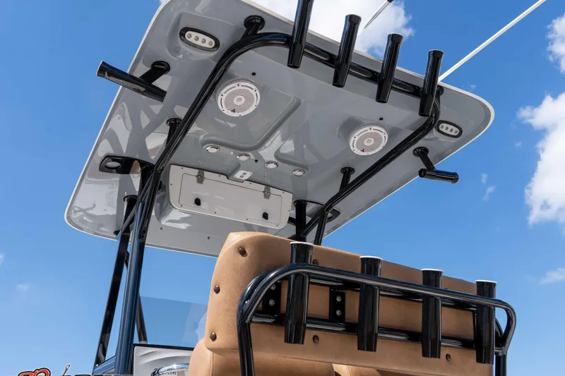 Slide: The Image of 2021 Sea Hunt Ultra 229 boat with T-top and rod holders against blue sky. - 19