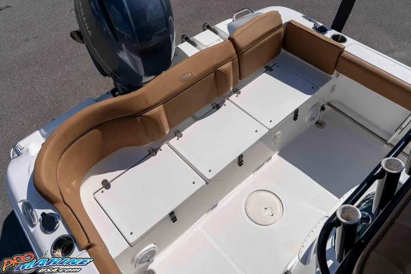 Slide: The Image of 2021 Sea Hunt Ultra 229 boat interior with cushioned seating and Yamaha engine. - 20