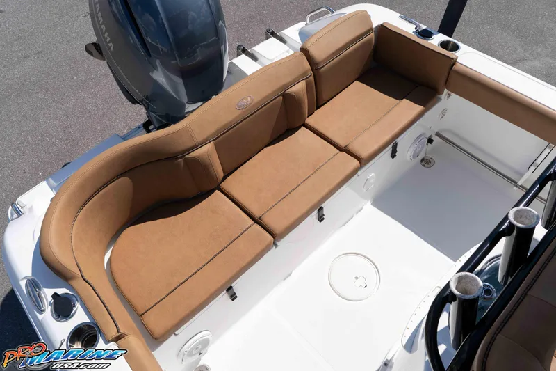 Slide: The Image of 2021 Sea Hunt Ultra 229 boat with tan seating and Yamaha engine. - 22