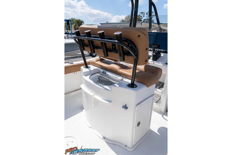 Slide: The Image of 2021 Sea Hunt Ultra 229 boat interior with tan seating and rod holders. - 23