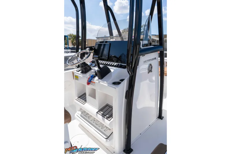 Slide: The Image of 2021 Sea Hunt Ultra 229 boat console with steering wheel and navigation equipment. - 25