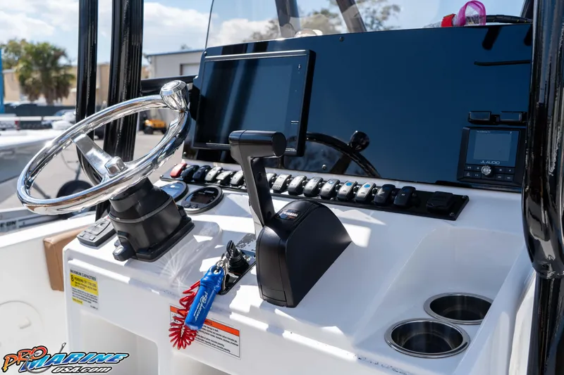 Slide: The Image of 2021 Sea Hunt Ultra 229 boat dashboard with steering wheel and controls. - 26
