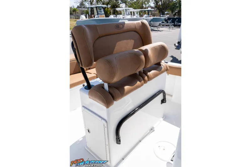 Slide: The Image of 2021 Sea Hunt Ultra 229 boat seat with tan upholstery and white base. - 28