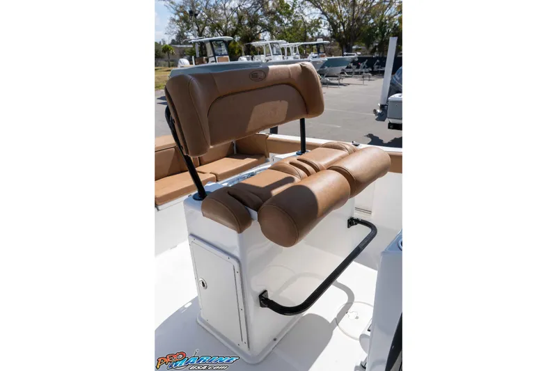 Slide: The Image of 2021 Sea Hunt Ultra 229 boat seat with tan upholstery and storage compartment. - 29