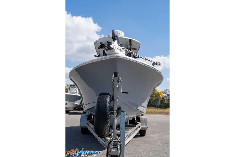 Slide: The Image of 2021 Sea Hunt Ultra 229 boat on trailer under clear blue sky. - 3