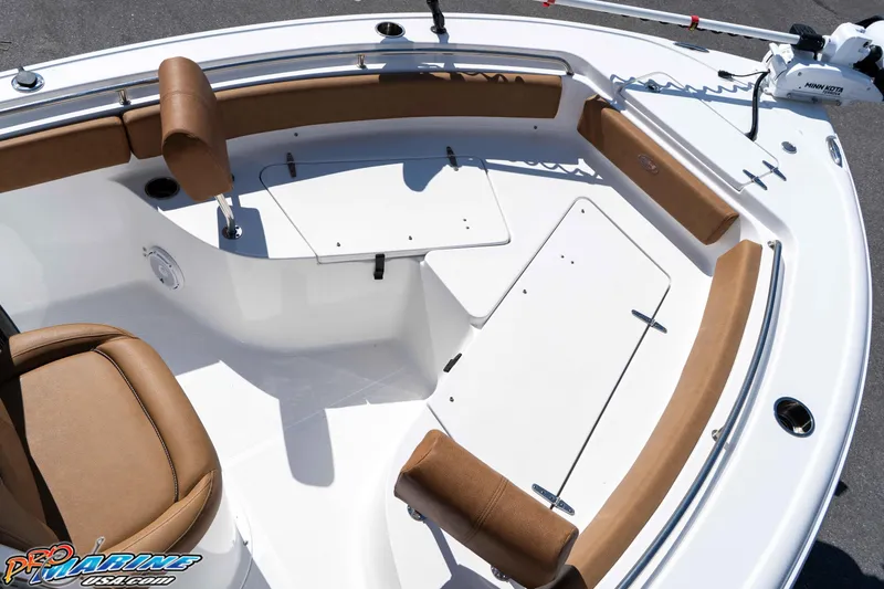 Slide: The Image of 2021 Sea Hunt Ultra 229 boat interior with tan seating and storage compartments. - 30