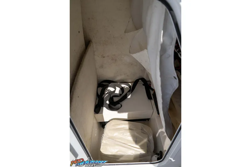 Slide: The Image of 2021 Sea Hunt Ultra 229 storage compartment with equipment and gear. - 34