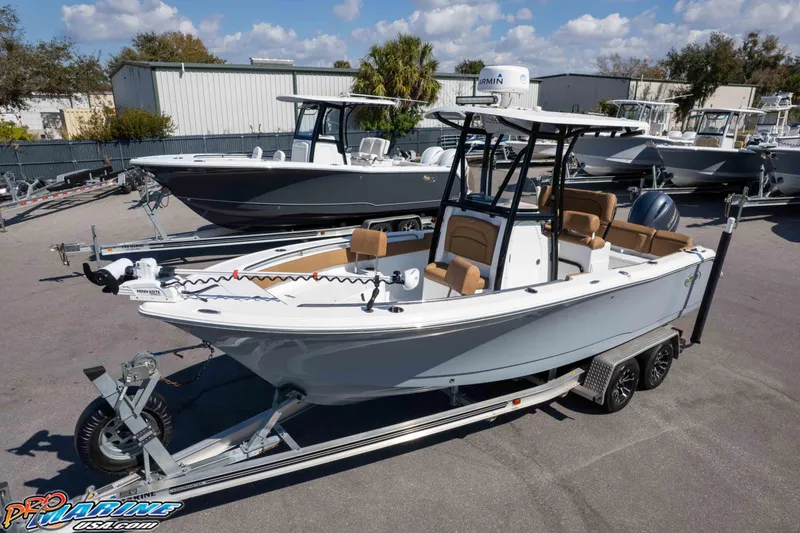 Slide: The Image of 2021 Sea Hunt Ultra 229 boat on trailer, parked outdoors under a clear sky. - 37