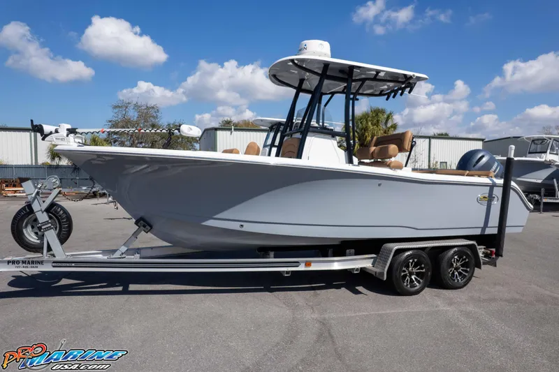 Slide: The Image of 2021 Sea Hunt Ultra 229 boat on trailer under blue sky. - 38