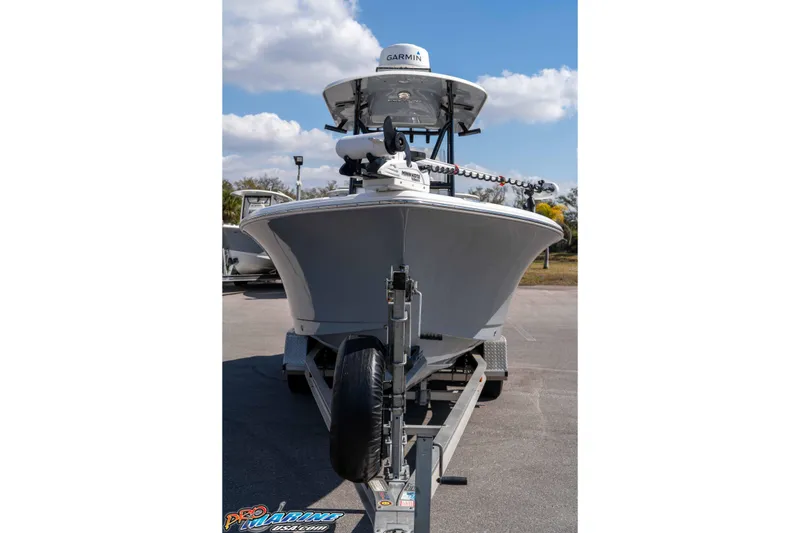 Slide: The Image of 2021 Sea Hunt Ultra 229 boat on trailer, front view under blue sky. - 4