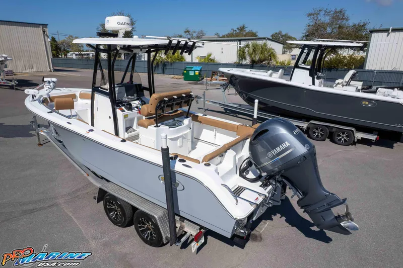 Slide: The Image of 2021 Sea Hunt Ultra 229 boat on trailer with Yamaha outboard motor, parked outdoors. - 42