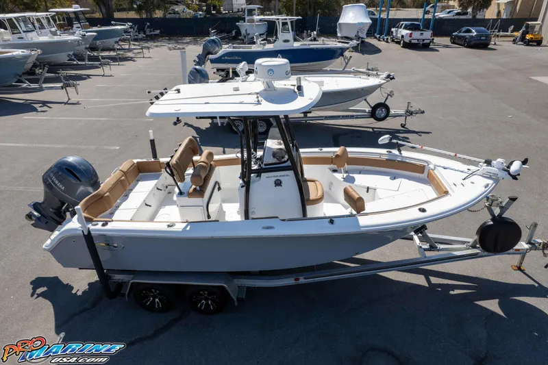 Slide: The Image of 2021 Sea Hunt Ultra 229 boat on trailer in marina parking lot. - 49