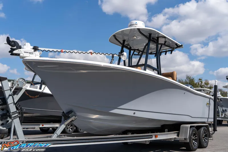 Slide: The Image of 2021 Sea Hunt Ultra 229 boat on trailer under blue sky. - 6