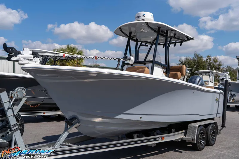 Slide: The Image of 2021 Sea Hunt Ultra 229 boat on trailer under blue sky. - 8