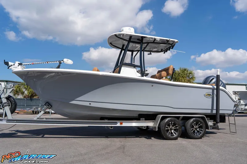 Slide: The Image of 2021 Sea Hunt Ultra 229 boat on trailer under blue sky. - 9