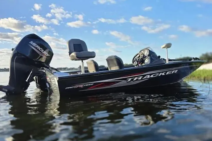 Slide: The Image of 2020 Tracker Pro Team 175 TF boat on calm water under blue sky. - 11