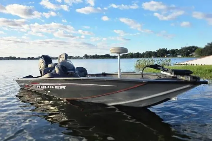 Slide: The Image of 2020 Tracker Pro Team 175 TF boat on a serene lake under a blue sky. - 14