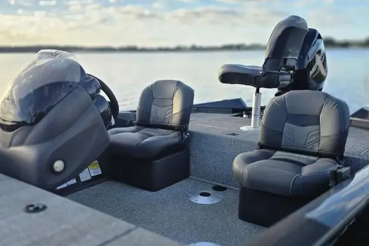 Slide: The Image of 2020 Tracker Pro Team 175 TF boat interior with comfortable seating on a calm lake. - 21