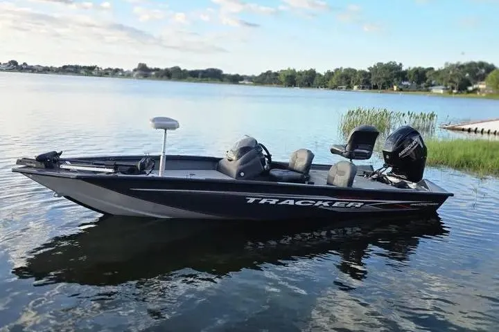 Slide: The Image of 2020 Tracker Pro Team 175 TF boat on a serene lake under a blue sky. - 3