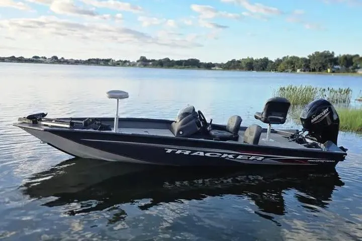 Slide: The Image of 2020 Tracker Pro Team 175 TF boat on a calm lake under a blue sky. - 4