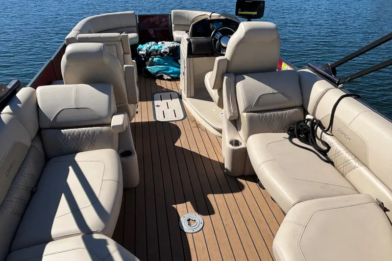 Slide: The Image of 2018 Coach Pontoons 230 RF with spacious seating on a calm lake. - 10