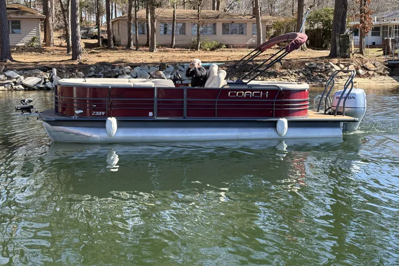 Slide: The Image of 2018 Coach Pontoons 230 RF on a calm lake near wooded shoreline. - 5
