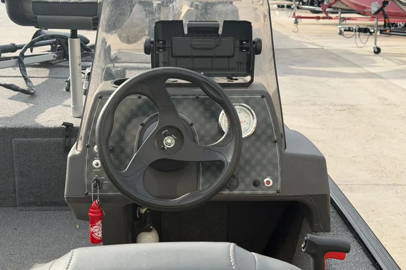 Slide: The Image of 2020 Tracker Bass Tracker Classic XL boat dashboard with steering wheel and gauges. - 8