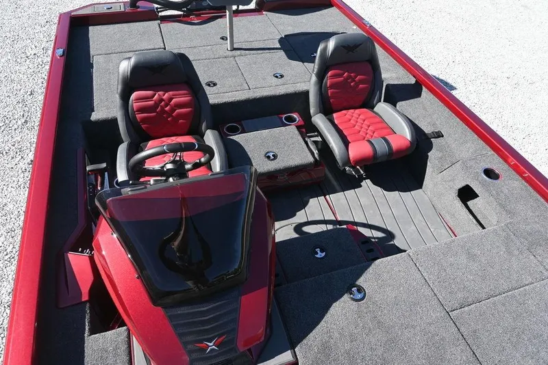 Slide: The Image of 2026 Vexus AVX 2100 boat interior with red and black seating, steering console, and carpeted flooring. - 13