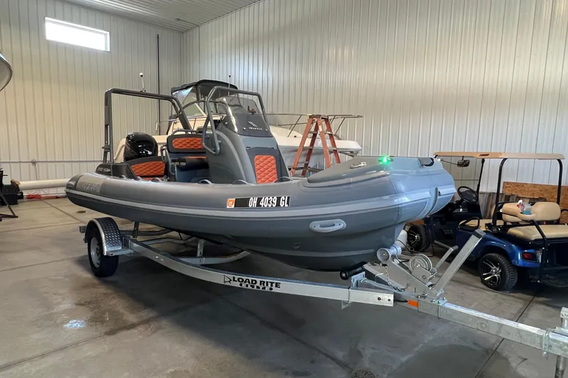 The Image of 2024 Highfield Sport 560 boat on trailer in indoor storage facility. - 0